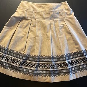 Ann Taylor LOFT tan skirt with Black and Tan design along bottom of skirt.